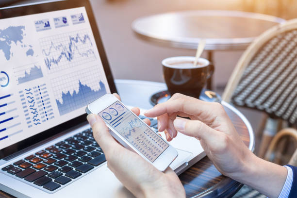 istock Businesswoman analyzing stock market KPI with BI, computer, smartphone screen 834792042