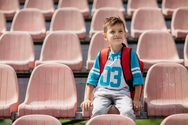 istock Young student sitting at a stadium and taking a break from school 834792768