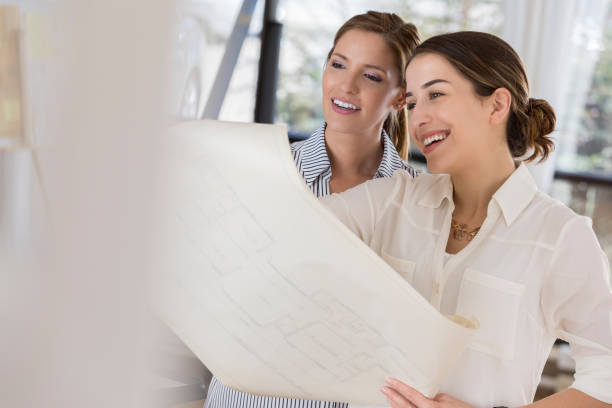istock Confident female architects review blueprints 834794826