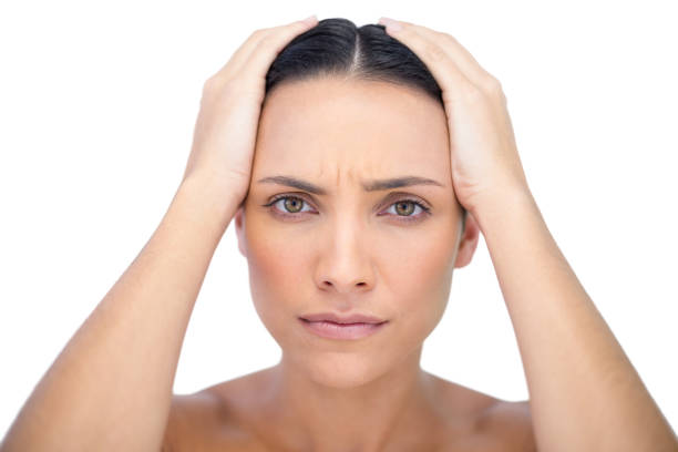 istock Young woman with headache touching her forehead 834799196