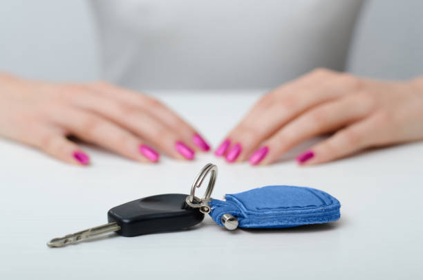 Young woman and car key on the table Young woman's hands with manicured fingernails and car keys on the table car keys table stock pictures, royalty-free photos & images