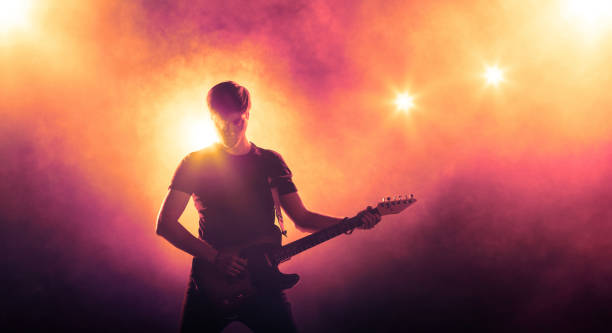 istock Silhouette of guitar player on stage 834800692