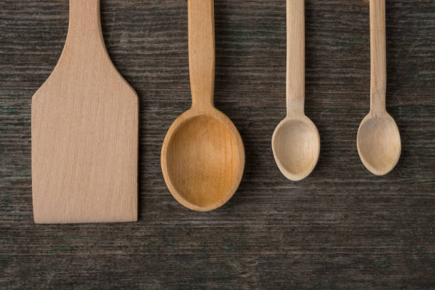istock Handmade wooden spoons on a wooden board, kitchen tools 834807984