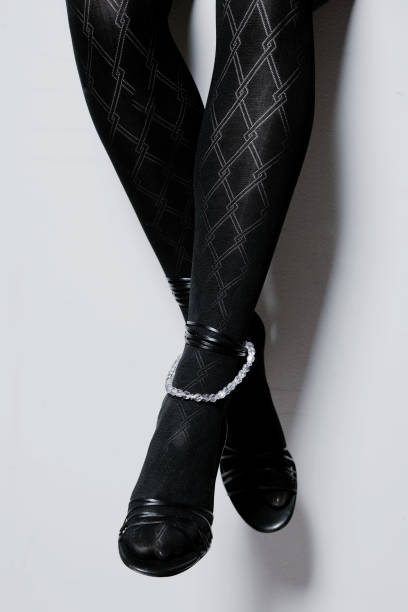 istock Elegant woman's legs in stocking and high heels with white copy space 834814610