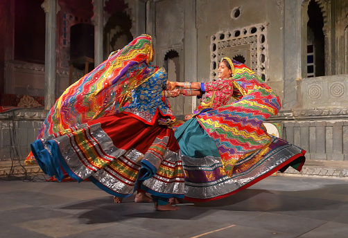 Udaipur, India - January 29, 2014: An unidentified young indian women in national costumes perform dance at a traditional festival exposing local Rajasthan culture in Udaipur, India
