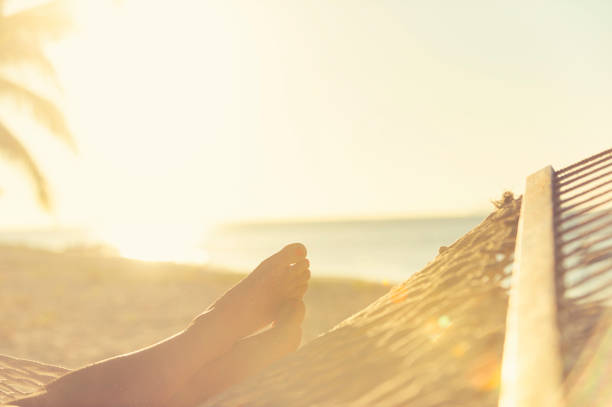 istock Woman lying in a hammock on the beach. 834829754
