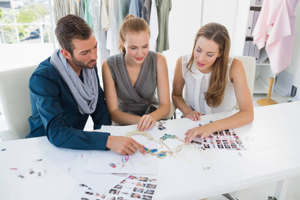 istock Three fashion designers discussing designs 834834108