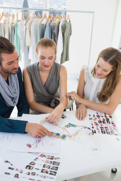 istock Three fashion designers discussing designs 834834220