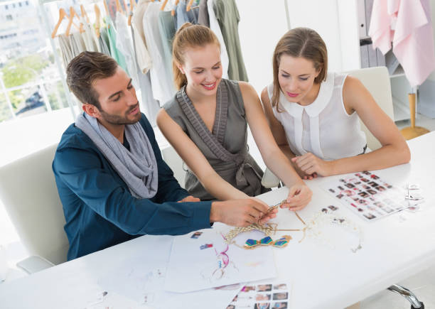 istock Three fashion designers discussing designs 834834420