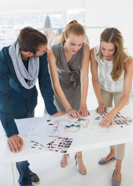 istock Three fashion designers discussing designs 834834536