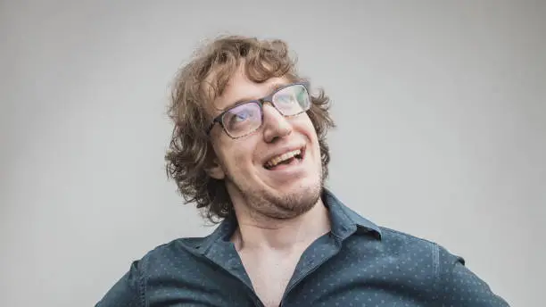 Photo of happy and proud man portrait on gray