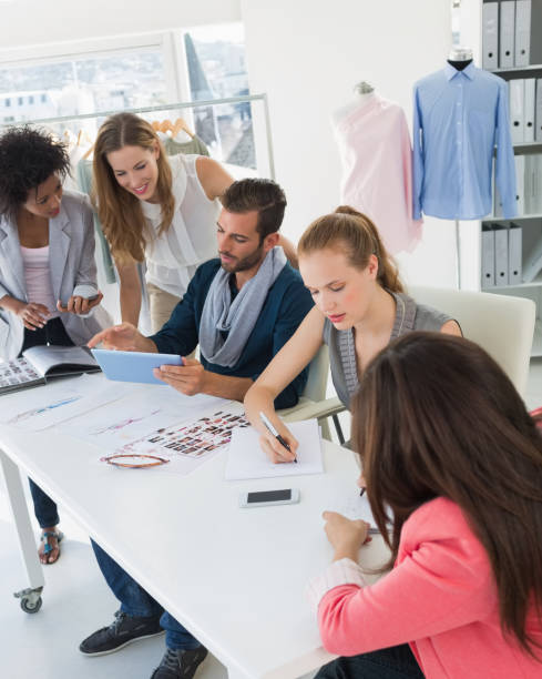 istock Fashion designers discussing designs 834835952