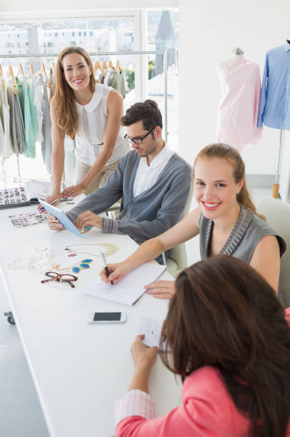 istock Fashion designers discussing designs 834835986