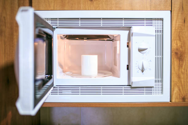 istock Cup of coffee in a microwave 834840800