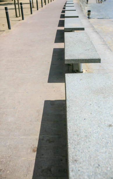 Stoned benchs in a row with its shadows