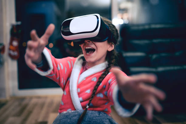 istock Little Girl Having Fun with Virtual Reality Simulator and Gesturing 834845182