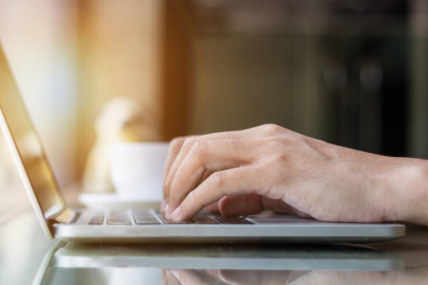 istock Hands typing on laptop in coffee shop 834867184