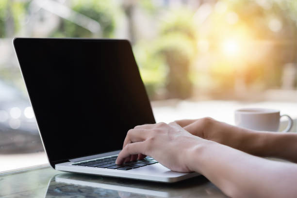 istock Hands typing on laptop in coffee shop 834867212