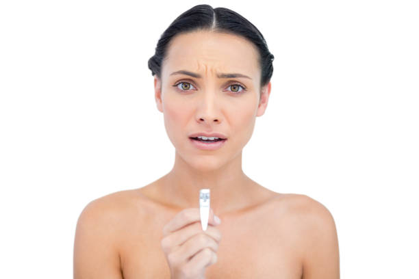 istock Anxious young brunette holding nail clippers 834868636