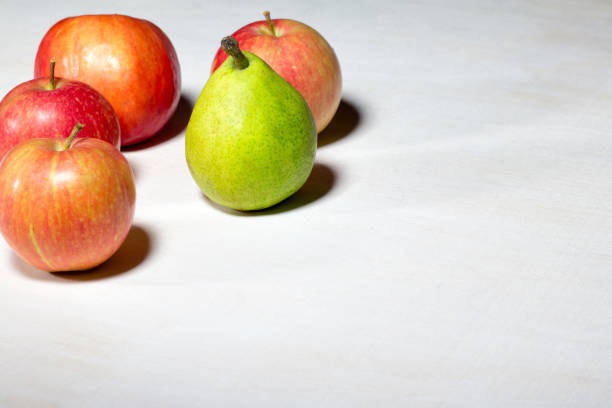 istock Apples and pears on a white wooden background 834883228