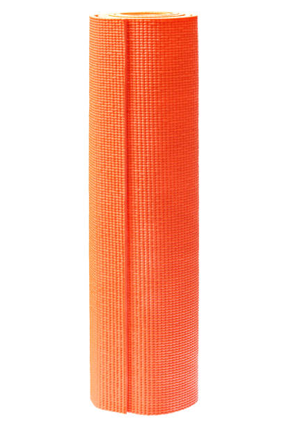 Orange yoga mat isolated on white background.