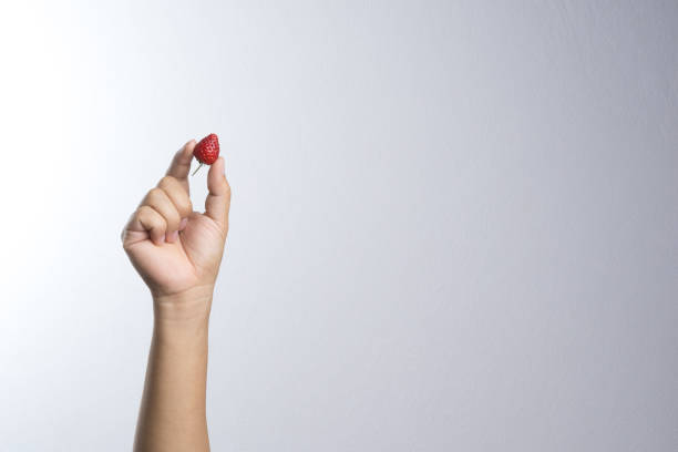 istock Hand holding fresh strawberry 834923544