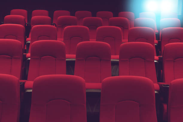 movie theater empty auditorium with red seats and blue lighting