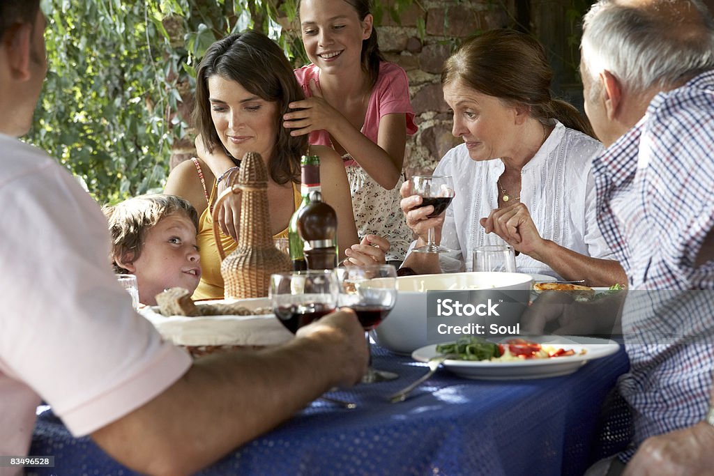 three generation family eating lunch outdoors  Eating Stock Photo