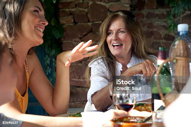 Mature Woman And Daughter Eating Lunch Outdoors Stock Photo - Download Image Now - Lunch, Mature Women, Daughter