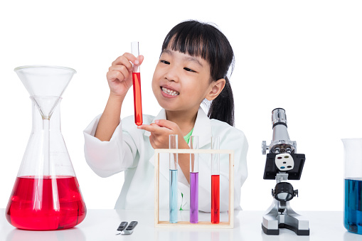 Asian Chinese little girl working with test tube in isolated white background