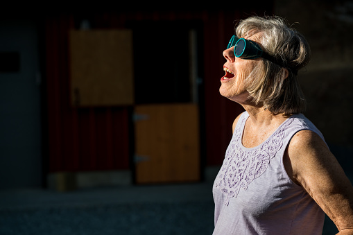 Senior woman watching a solar eclipse