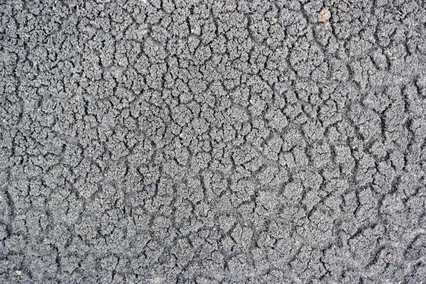 Cracks in the ground barren surface abstract background.