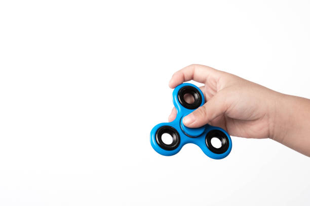 istock finger spinner stress, anxiety relief toy on white background. 834995050