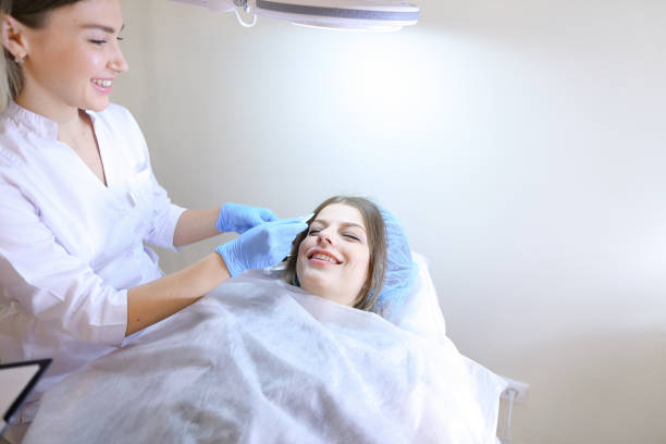 istock Professional female master of manual tattoo engaged in adjusting 834996210