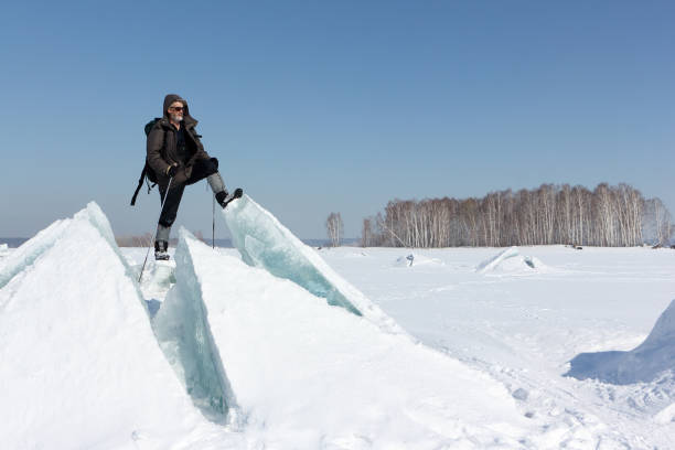 istock Man in sunglasses standing on cracked ice 834996686
