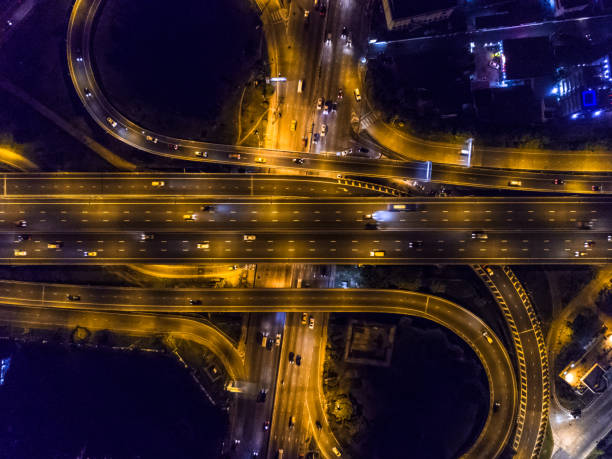 istock Highway night time with car and traffic, Drone view from night sky 835002910