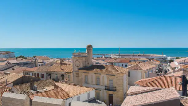 Saintes-Maries-de-la-Mer in Camargue, panorama of the town, tiles roofs, and the sea, view from the church