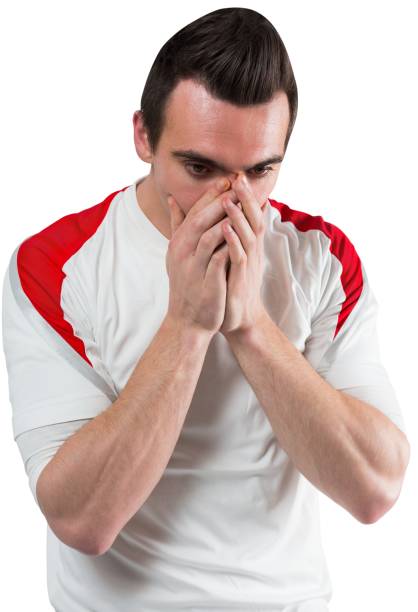 istock Disappointed football fan looking down 835008404
