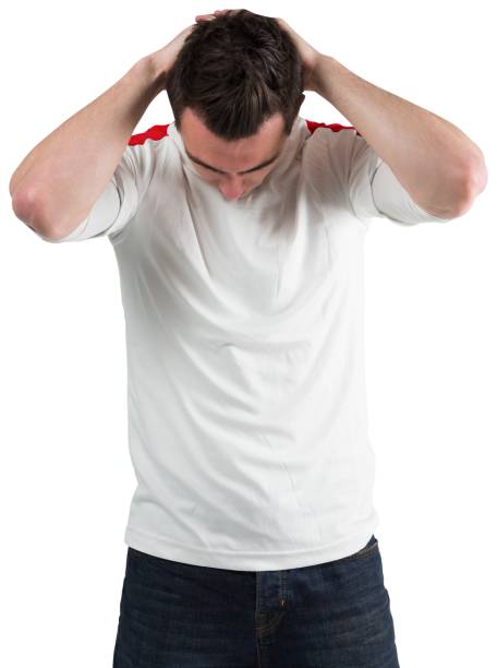 istock Disappointed football fan looking down 835008476