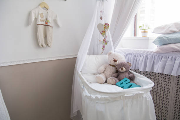 istock Baby cot with teddy bears in the room 835010504
