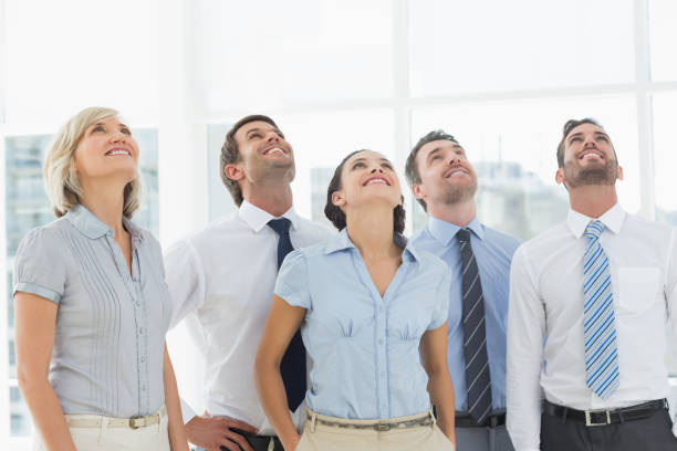 istock Business team looking up in office 835017562