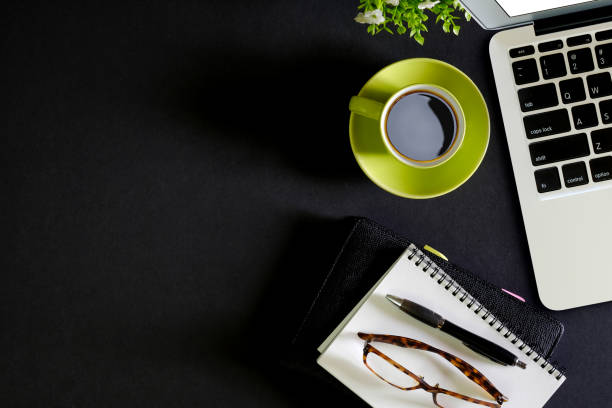 istock Office leather dark desk table with computer, supplies and coffee cup. Top view with copy space 835035648