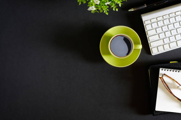 istock Office leather dark desk table with computer, supplies and coffee cup. Top view with copy space 835035736