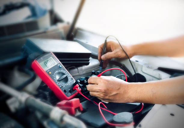 Battery. Close up of auto mechanic jumping battery car,check voltage level car battery. multimeter stock pictures, royalty-free photos & images