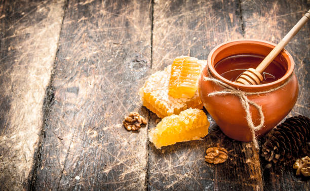 istock The honey in the pot with the nuts and cones. 835036572