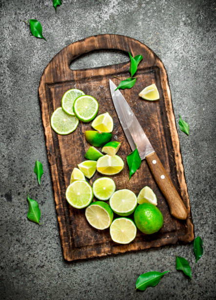 istock Sliced fresh limes on a cutting Board with a knife . 835037456