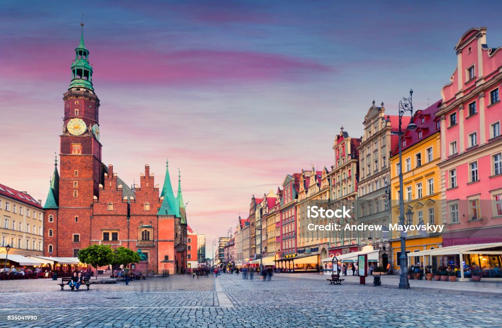 Colorful evening scene on Wroclaw Market Square with Town Hall. Colorful evening scene on Wroclaw Market Square with Town Hall. Sunset in historical capital of Silesia, Poland, Europe. Artistic style post processed photo. Wroclaw Stock Photo
