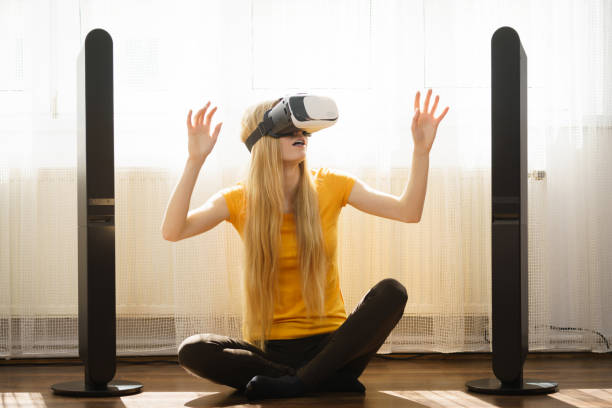 istock Girl wearing virtual reality goggles at home 835050492