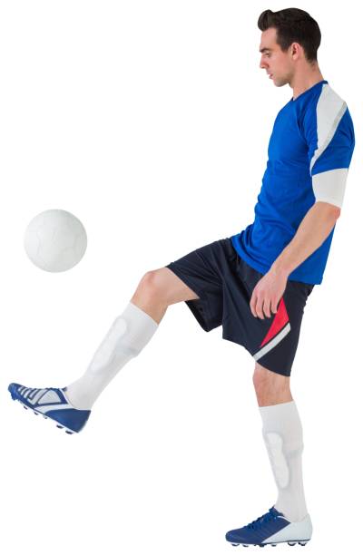 istock Football player in blue kicking ball 835061256