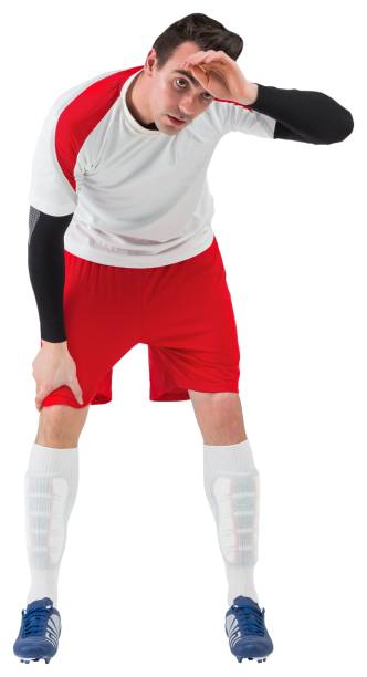 istock Football player in white catching his breath 835061798